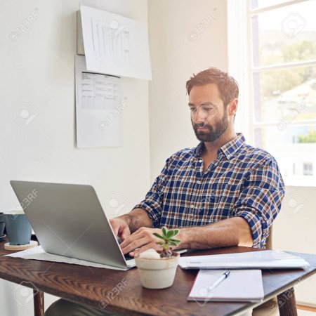 191053067-getting-down-to-business-a-man-sitting-at-a-desk-working-on-a-laptop